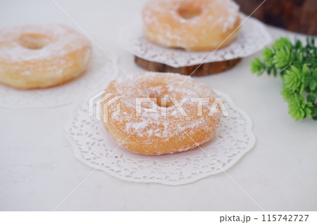 donuts with powdered sugar on top as a background 115742727