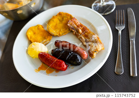 Spanish grill plate of sausages, pork slice, and fried eggplants Spanish grill plate of sausages, pork slice, and fried eggplants 115743752