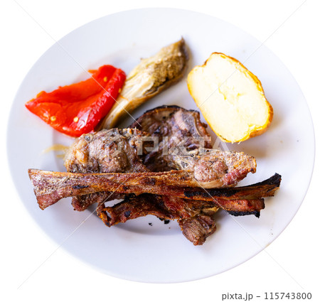 Roasted lamb ribs, pepper and potato slices served Roasted lamb ribs, pepper and potato slices served 115743800
