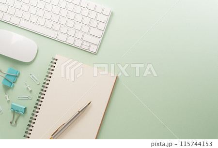 Flat lay, top view office table desk. Workspace with keyboard, office supplies and flower on pastel background. Flat lay, top view office table desk. Workspace with keyboard, office supplies and flower on pastel background. 115744153
