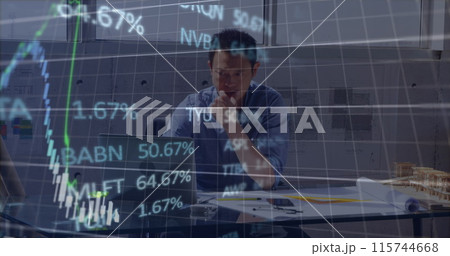 Stock market data processing over asian male engineer using laptop at office 115744668