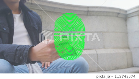 Image of fingerprint over biracial man using smartphone 115745374
