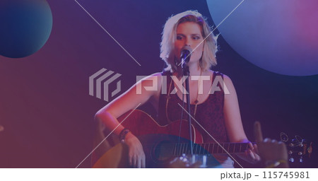 Image of spheres over caucasian woman playing acoustic guitar and singing into microphone 115745981