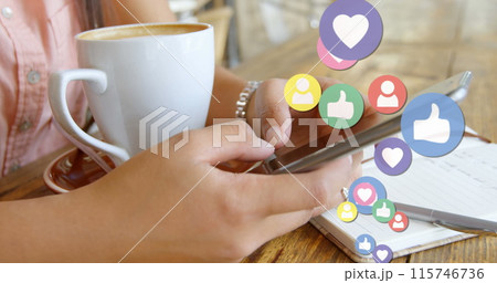 Close up of a woman texting with a coffee on the table and social media icons floating on the right 115746736