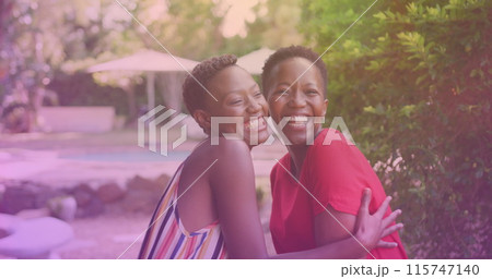 Two african american sisters hugging each other at a resort Two african american sisters hugging each other at a resort 115747140