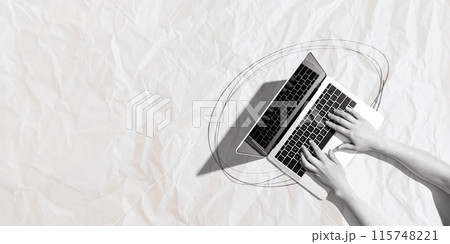 Person using a laptop computer with crumpled paper texture 115748221