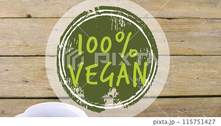 Image of 100 percent vegan text over bowl of fresh fruit 115751427