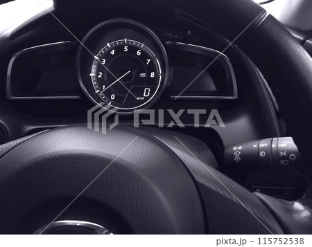 Interior view of car speedometer with steering wheel. 115752538