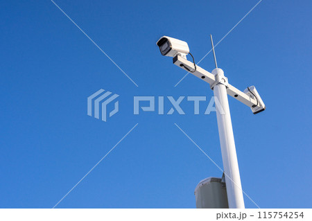 Security camera cover with ice and snow against blue sky background Security camera cover with ice and snow against blue sky background 115754254