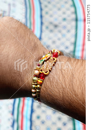 Brother showing rakhi on his hand on an occasion of Raksha Bandhan festival. 115754775