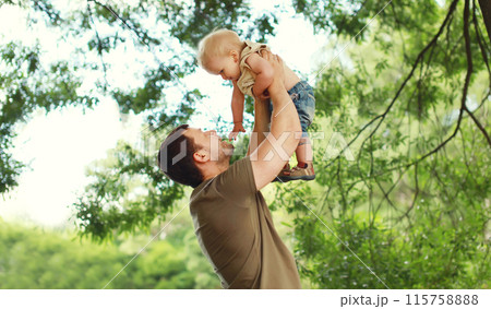 Happy father and son, joyful dad playing with child, holding on hands in the park 115758888