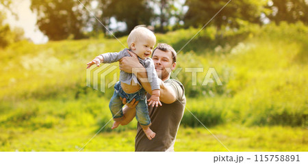 Happy father and son, joyful dad playing with child, holding on hands in the park 115758891