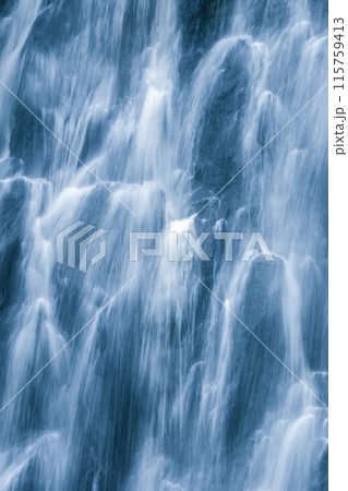 The water flows down from the rock cliff. It hits the cliff and creates mist The water flows down from the rock cliff. It hits the cliff and creates mist 115759413