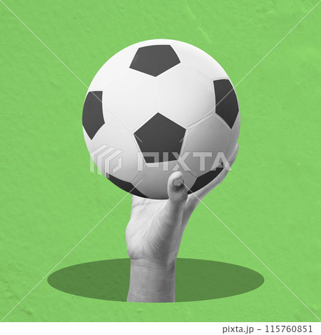 A human hand holding a soccer ball 115760851