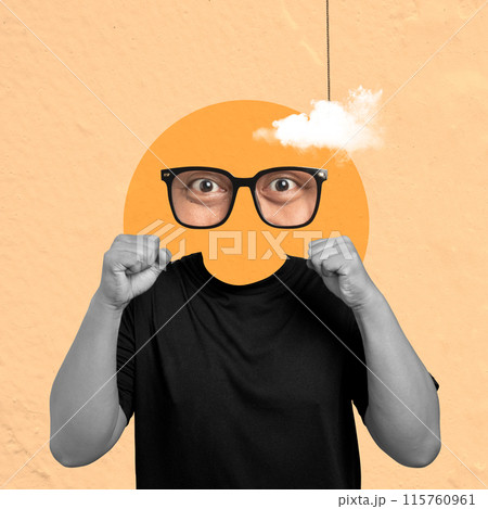 A man with a black shirt and glasses is punching a hole in an orange circle 115760961