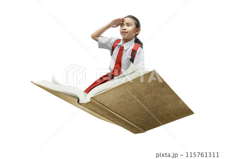 Portrait of an Asian Elementary School student girl in uniform with a backpack sitting on the opened book while looking ahead Portrait of an Asian Elementary School student girl in uniform with a backpack sitting on the opened book while looking ahead 115761311