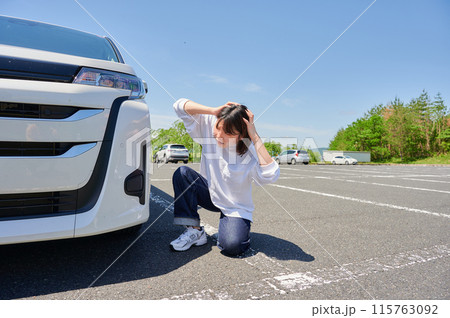 車の前で頭を抱える女性 パンク トラブル 車の前で頭を抱える女性 パンク トラブル 115763092