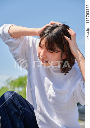 車の前で頭を抱える女性　パンク　トラブル 115763385