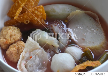 boiled fish and shrimp ball couple dumpling topping pickled cuttlefish in red soybean sauce soup on bowl 115765013