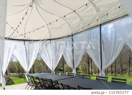 Party tent, white garden party, wedding entertainment tent in modern garden. High quality photo 115765277
