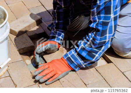 In reconstruction, brick path that has been destroyed is replaced with new part that is broken 115765362