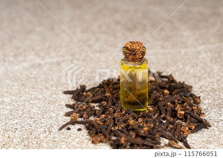 Natural clove oil in glass bottle among dried cloves Natural clove oil in glass bottle among dried cloves 115766051