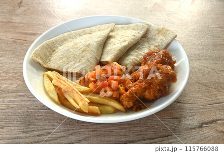 Quesadilla Mexican pizza stuffing mashed spicy chicken with French fries and barbecue buffalos wing topping sour salad on plate Quesadilla Mexican pizza stuffing mashed spicy chicken with French fries and barbecue buffalos wing topping sour salad on plate 115766088