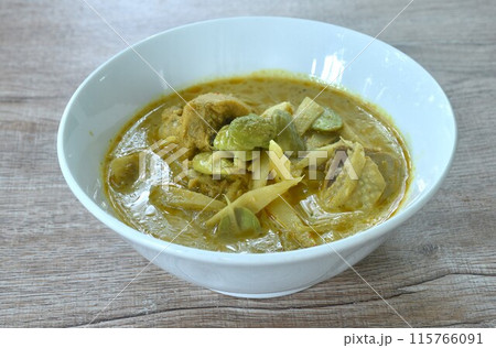 spicy boiled slice fresh bamboo shoot with chicken topping stink bean in coconut milk curry soup on bowl spicy boiled slice fresh bamboo shoot with chicken topping stink bean in coconut milk curry soup on bowl 115766091