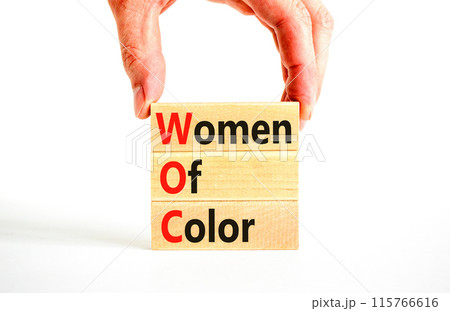 WOC women of color symbol. Concept words WOC women of color on beautiful wooden blocks. Beautiful white background. Businessman hand. Business WOC women of color social issues concept. Copy space. 115766616