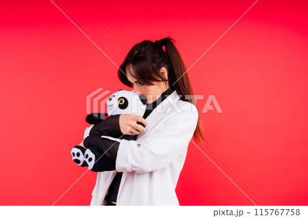 Portrait of cute woman posing in studio with panda 115767758