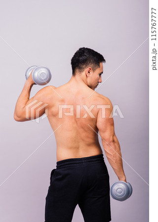 Shirtless bodybuilder showing his great body and holding dumbell. Shirtless bodybuilder showing his great body and holding dumbell. 115767777