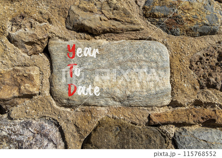 YTD year to date symbol. Concept words YTD year to date on beautiful big stone. Beautiful stone wall background. Business YTD year to date concept. Copy space. 115768552
