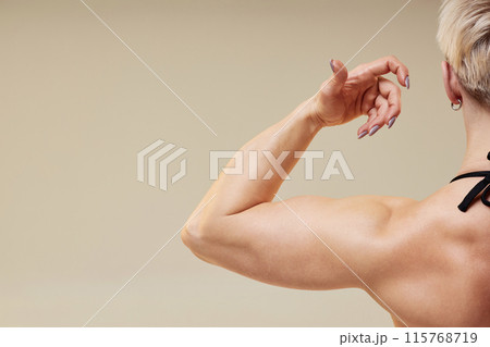 Cropped close up on unrecognizable strong sportswomans arm. Cropped close up on unrecognizable strong sportswomans arm. 115768719