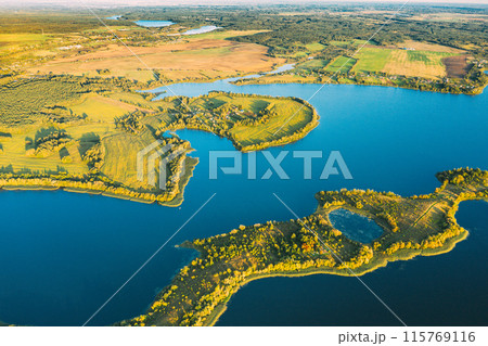 Top View Of European Nature From High Attitude In Summer Season. Amazing Scenic Aerial Bright Sunbeams View Green Meadow And River Landscape In Sunny Spring Day. Drone View. Bold Colors Top View Of European Nature From High Attitude In Summer Season. Amazing Scenic Aerial Bright Sunbeams View Green Meadow And River Landscape In Sunny Spring Day. Drone View. Bold Colors 115769116