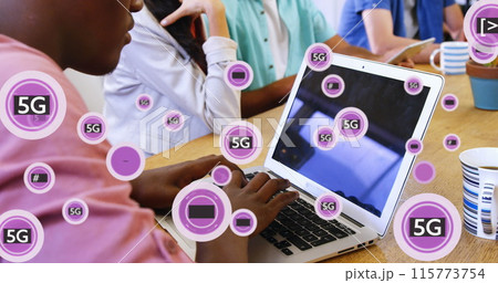 Image of 5g text with symbols over african american man working on laptop in office 115773754