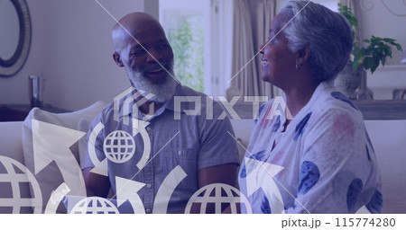 Image of icons over happy senior african american couple sitting on sofa 115774280