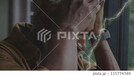 Image of lightning over sad senior african american man 115774389