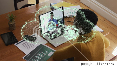 Image of setting over a cloud icon over african american woman having a image call on laptop Image of setting over a cloud icon over african american woman having a image call on laptop 115774773