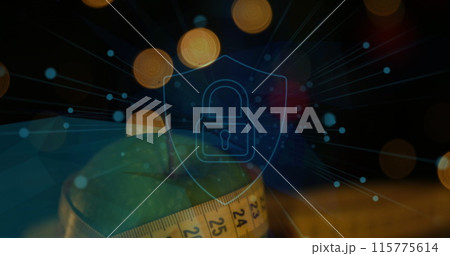 Image of padlock and shield icon with lens flares over granny smith apple and measuring tape Image of padlock and shield icon with lens flares over granny smith apple and measuring tape 115775614