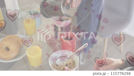 Image of heart emojis over caucasian woman pouring coffee 115776298