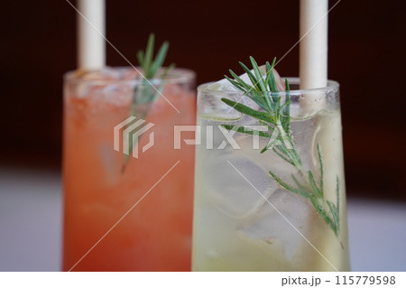 Refreshing summer cocktails with ice and rosemary on the table 115779598