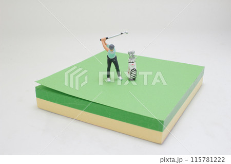 Golfer Figurine on Golf Ball on the memo pad Golfer Figurine on Golf Ball on the memo pad 115781222