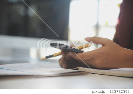 Asian businesswoman in formal suit in office happy and cheerful during using smartphone and working 115782593