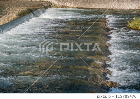 鴨川の堰を流れ落ちる水 115785476