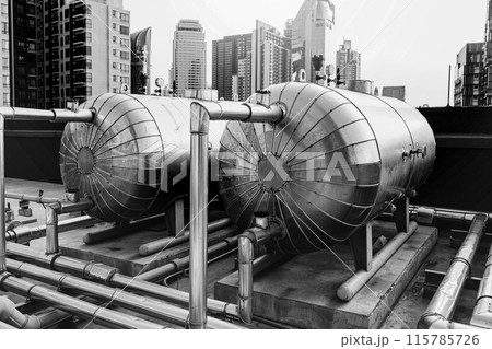 Boilers in Tank boiler hot water container delivery pipe line at roof top outdoor hotel infrastructure watering system. Boilers in Tank boiler hot water container delivery pipe line at roof top outdoor hotel infrastructure watering system. 115785726