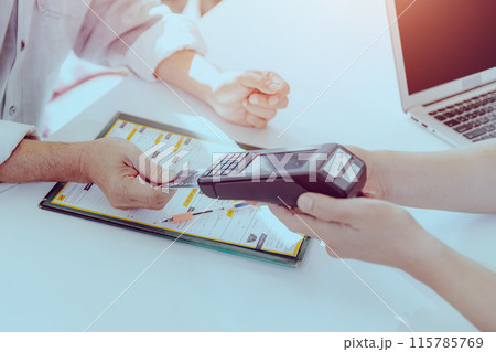 Customer using Credit Card payment with portable Swipe Magnetic Credit Card Reader Terminal machine. Customer using Credit Card payment with portable Swipe Magnetic Credit Card Reader Terminal machine. 115785769