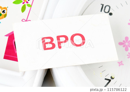 Text BPO Business Process Outsourcing text on the business card on the background of the clock 115786122