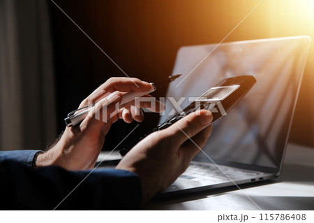 businessman working on desk office with using a calculator to calculate the numbers, finance accounting concept businessman working on desk office with using a calculator to calculate the numbers, finance accounting concept 115786408