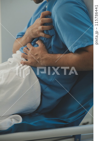 Male patient consulting a medical specialist at hospital. Chest pain and inflammatory heart disease 115786441