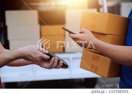 Asian delivery express courier young man use giving boxes to woman customer he wearing protective face mask at front home 115786501